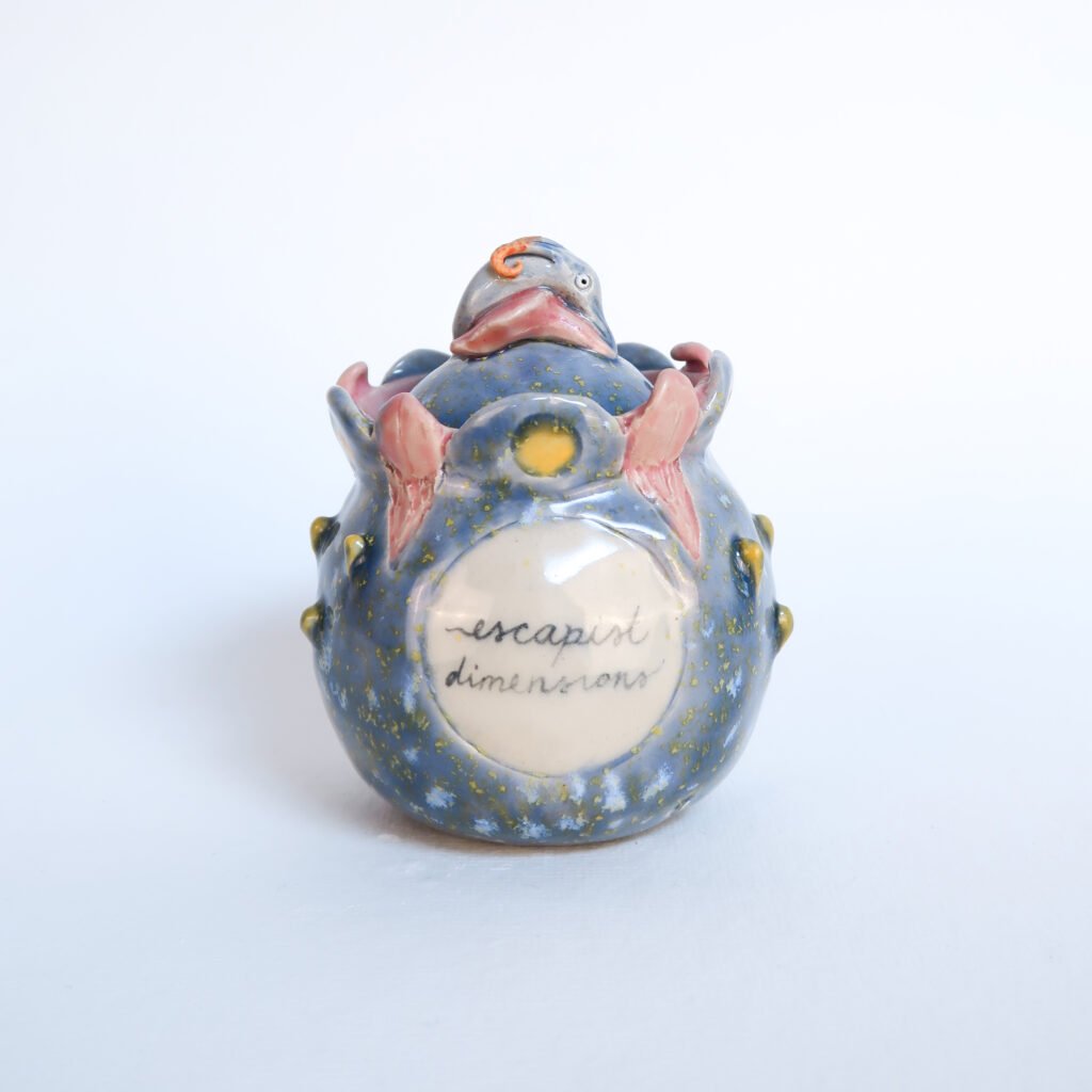 a handbuilt ceramic vessel with lid fantasy undersea the sea vibes and the words escapist dimensions