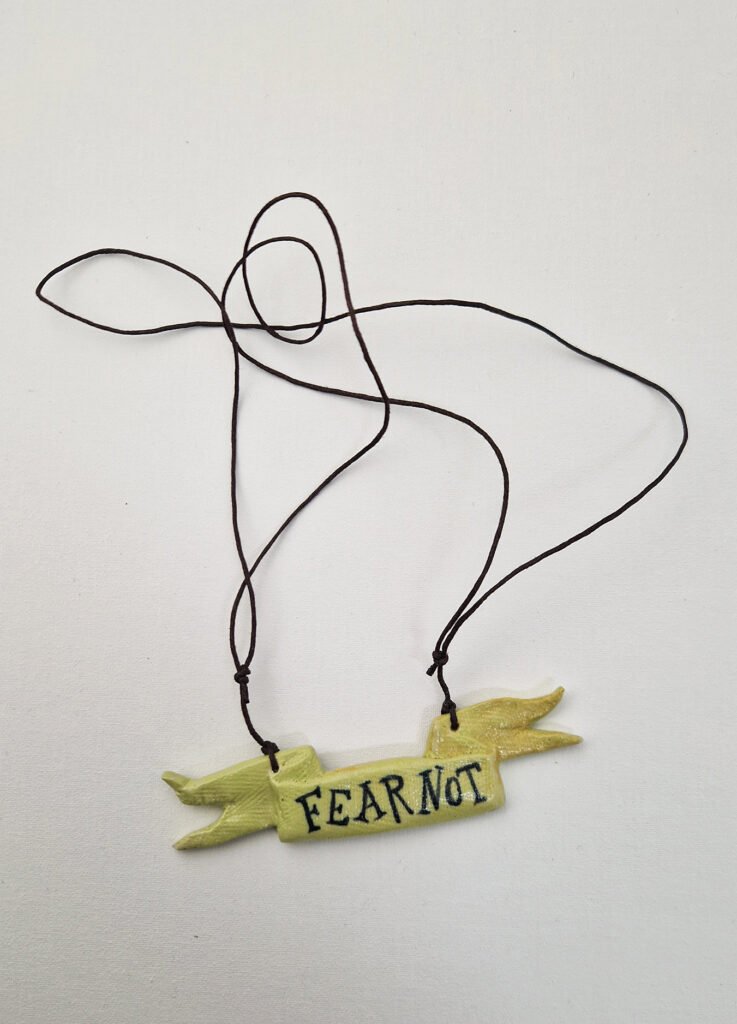 ceramic pendant with the text fear not