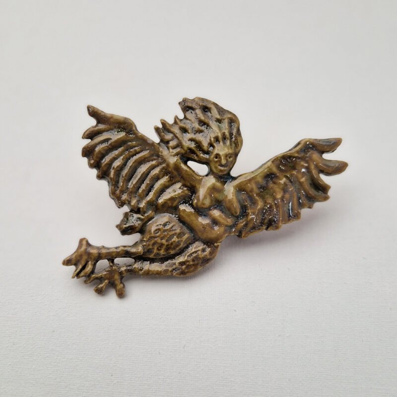 ceramic brooch depicting a harpy