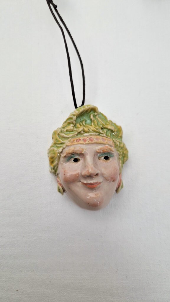 a ceramic pendant of a sculpted pendant head