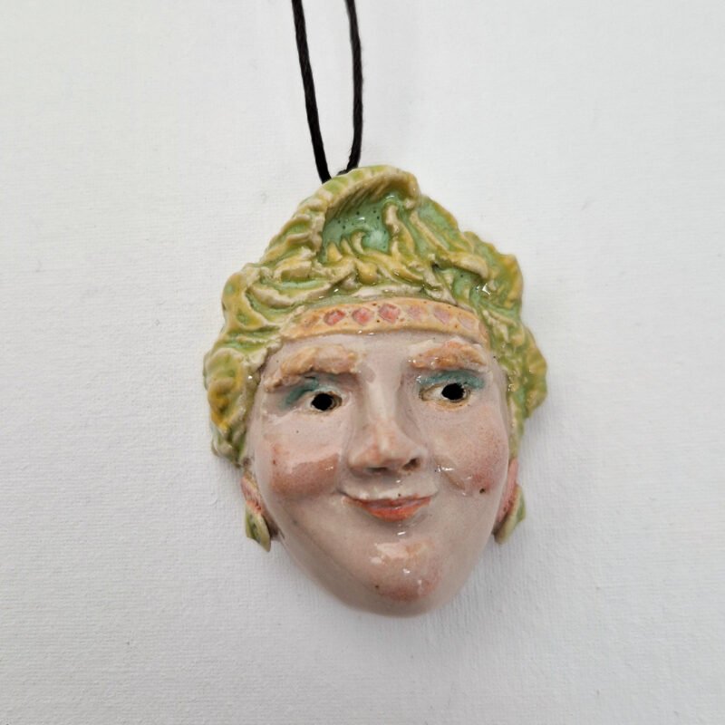 a ceramic pendant of a sculpted pendant head