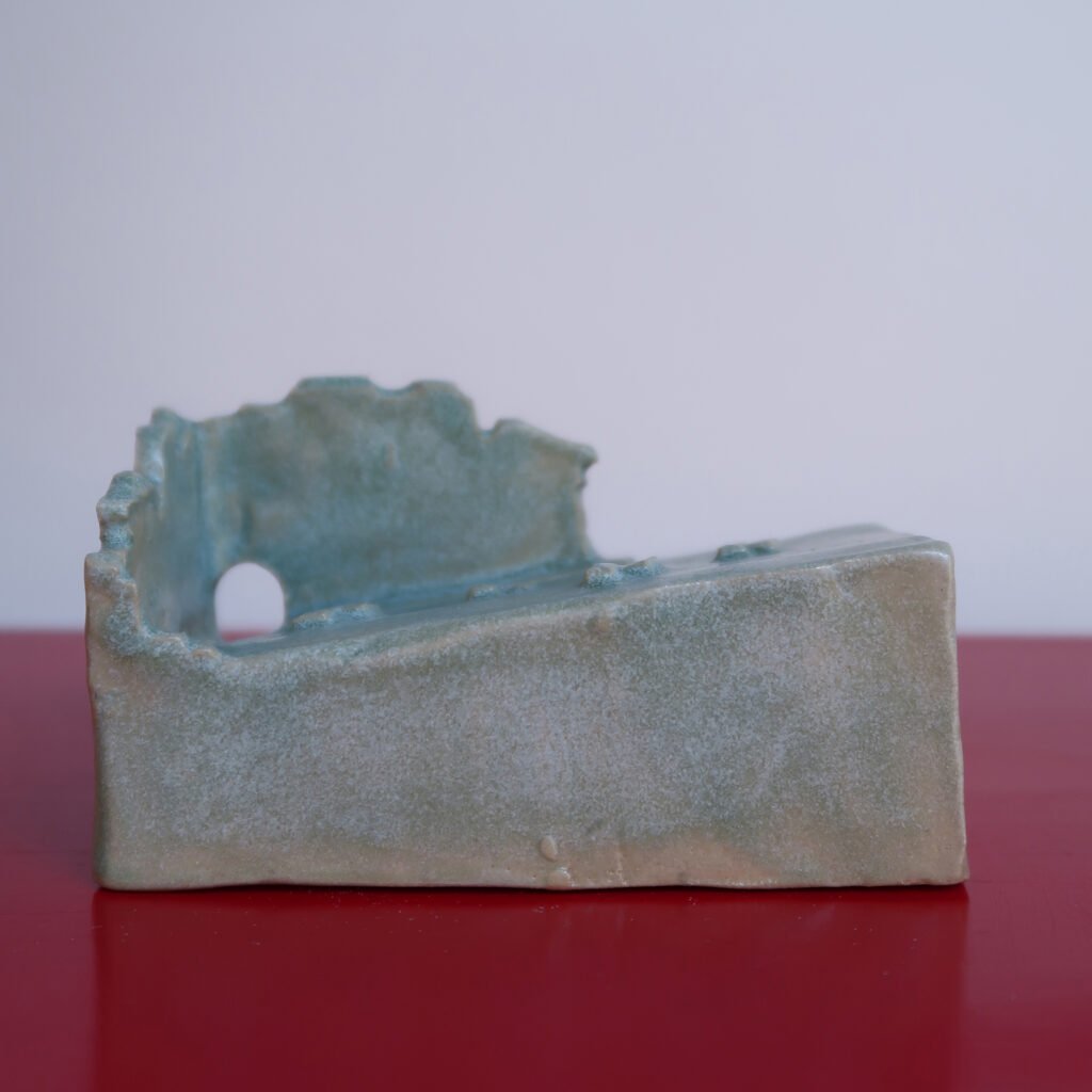 photo of a self-draining ceramic soap dish the shape of a rudimentary ruin