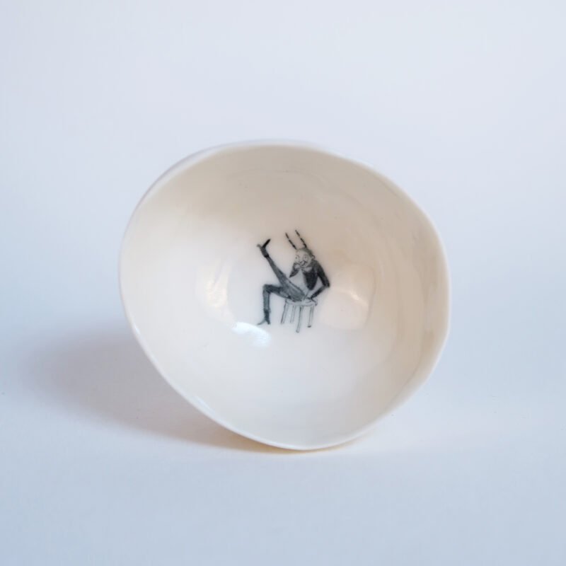 porcelain tea bowl with an underglaze painting of a cabaret bug