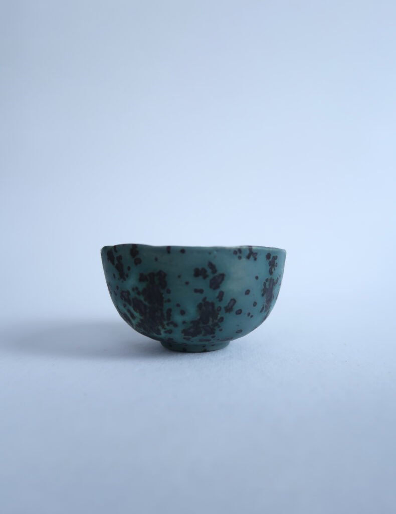 photo of a small tea bowl glazed like a blue moon